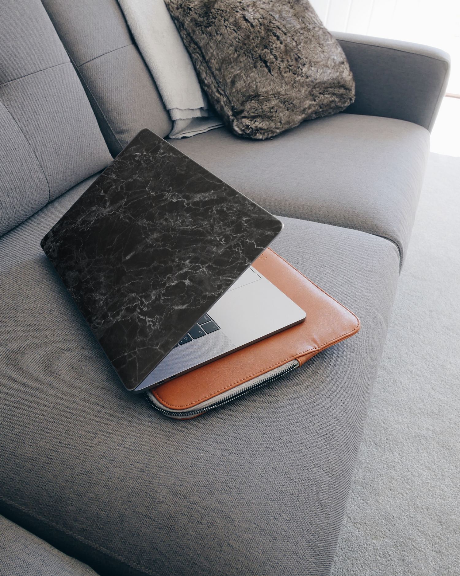 Midnight Marble Laptop Aufkleber für 15 Zoll Apple MacBooks auf dem Sofa